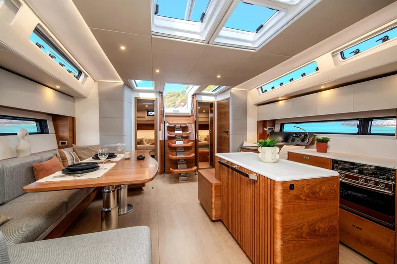 Slide: The Image of Luxurious interior of 2026 Hanse 590 yacht with modern kitchen and dining area. - 6