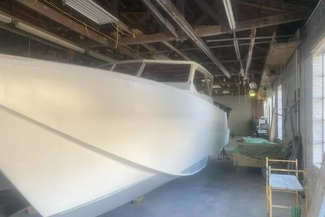 The Image of 2027 Compmillenia Lightspeed Tender boat in a workshop, under construction. - 1