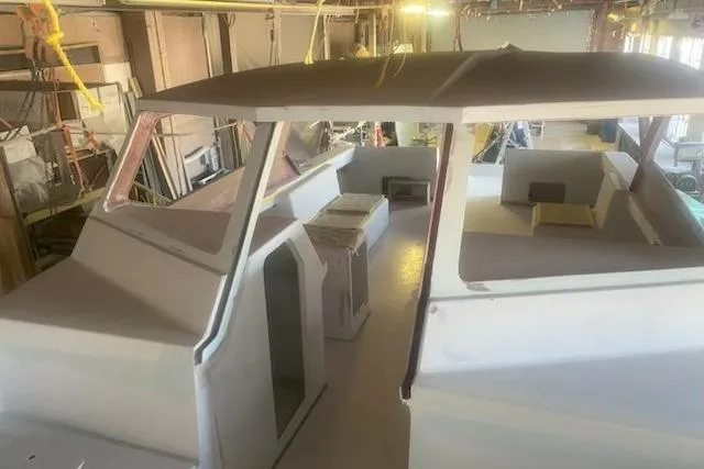 Slide: The Image of 2027 Compmillenia Lightspeed Tender under construction in a workshop setting. - 5