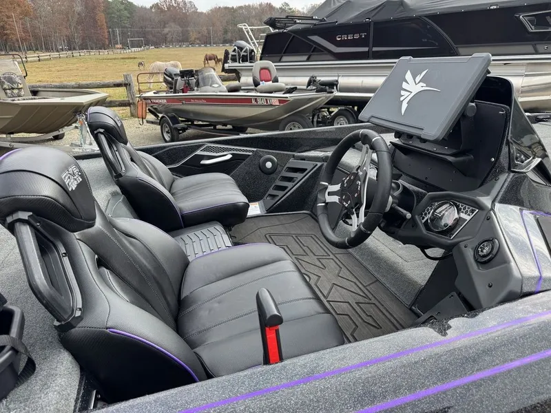 Slide: The Image of 2024 Skeeter FXR20 Limited Bass boat interior with sleek black seats and modern dashboard. - 3
