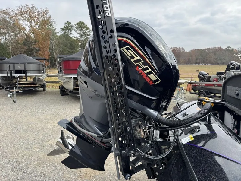 Slide: The Image of 2024 Skeeter FXR20 Limited Bass boat with Yamaha VMAX SHO engine in a marina setting. - 6