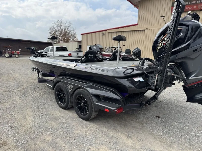 Slide: The Image of 2024 Skeeter FXR20 Limited Bass boat on trailer, parked outdoors. - 7