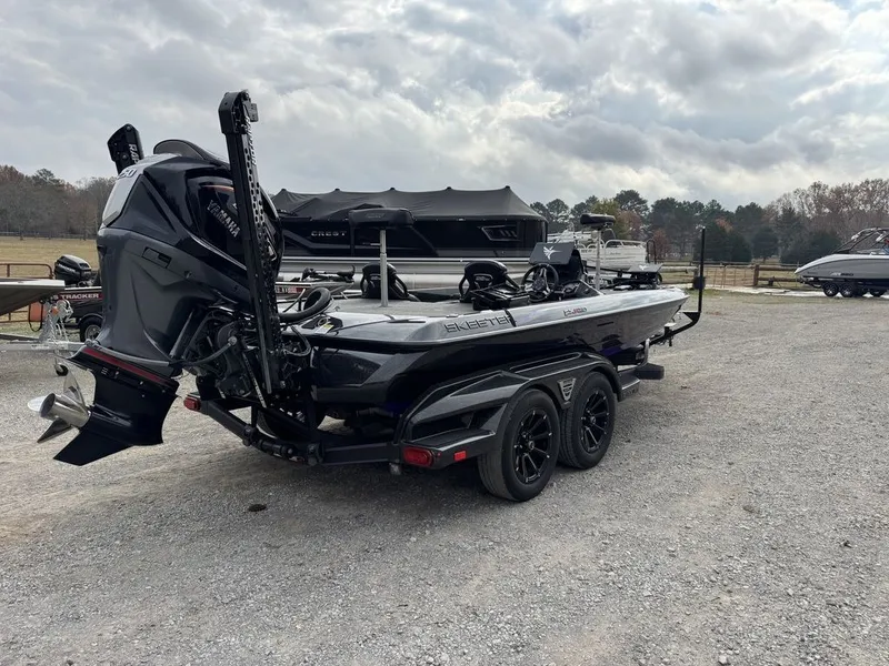 Slide: The Image of 2024 Skeeter FXR20 Limited Bass boat on trailer, parked outdoors under cloudy sky. - 8