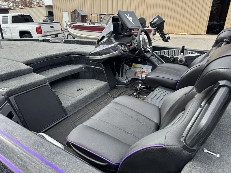 Slide: The Image of 2024 Skeeter FXR20 Limited Bass boat interior with black seats and advanced dashboard. - 9