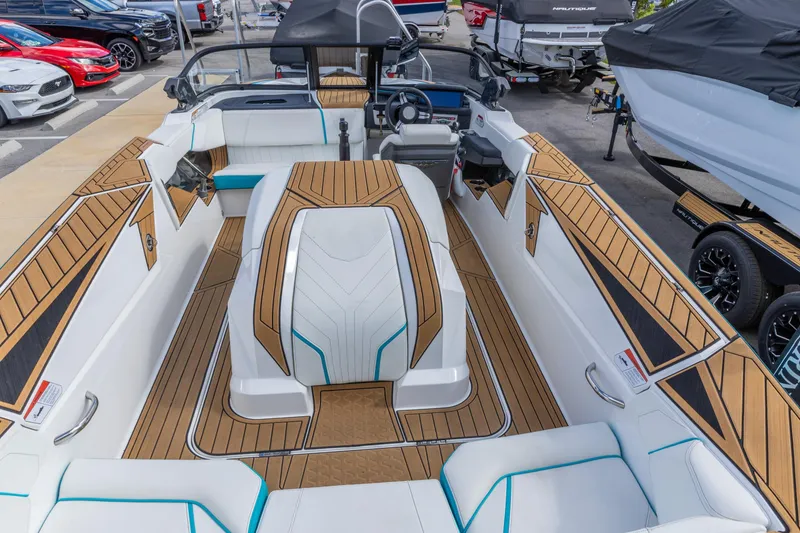 Slide: The Image of 2023 Nautique Ski Nautique boat interior with sleek design and wood accents. - 10