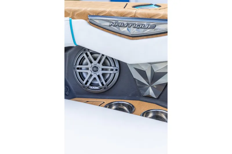 Slide: The Image of 2023 Nautique Ski Nautique interior detail with speaker and cup holders. - 11