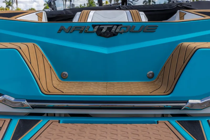 Slide: The Image of 2023 Nautique Ski Nautique boat, blue and tan design, rear view. - 17
