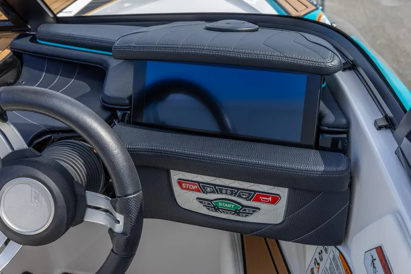Slide: The Image of 2023 Nautique Ski Nautique dashboard with steering wheel and digital display. - 3