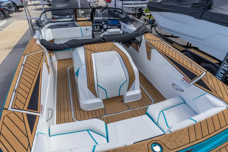 Slide: The Image of 2023 Nautique Ski Nautique boat interior with teak flooring and white seating. - 4