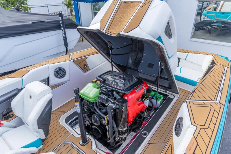 Slide: The Image of 2023 Nautique Ski Nautique boat engine compartment with open hatch, showcasing interior design. - 5