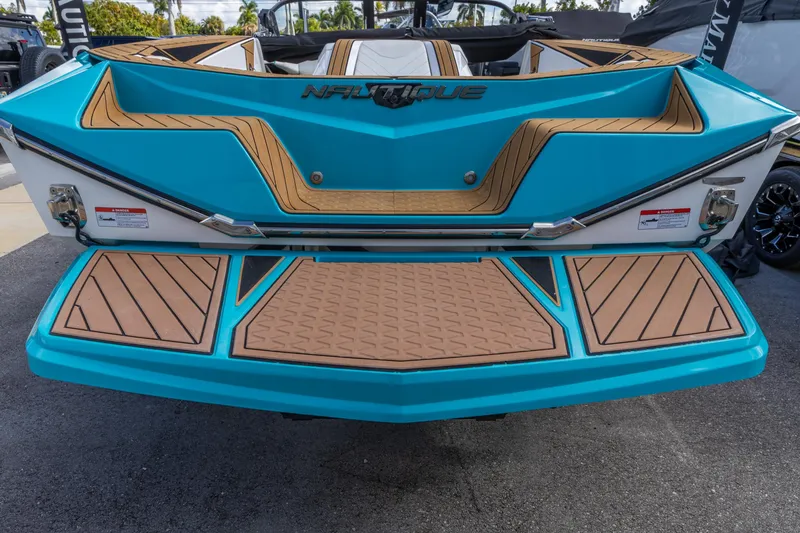 Slide: The Image of 2023 Nautique Ski Nautique boat with blue and tan deck design. - 6