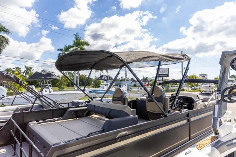 The Image of 2026 Viaggio Lago Z-S boat with canopy, parked outdoors under a sunny sky. - 0
