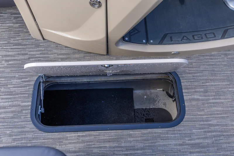 Slide: The Image of Open storage compartment on 2026 Viaggio Lago Z-S boat, featuring carpeted interior. - 17