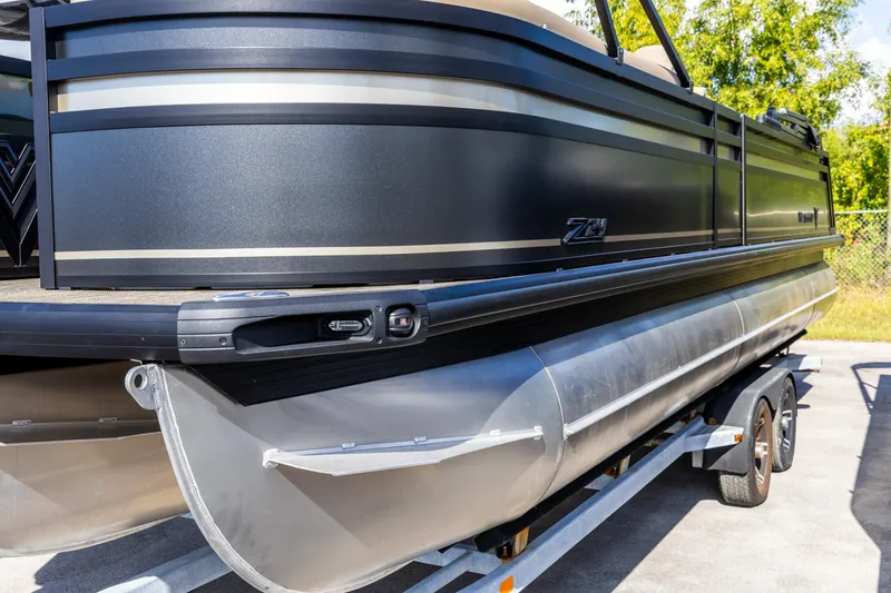 Slide: The Image of 2026 Viaggio Lago Z-S pontoon boat on trailer, sleek black design. - 2