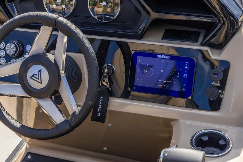 Slide: The Image of Viaggio Lago Z-S 2026 boat dashboard with steering wheel and Simrad display. - 3