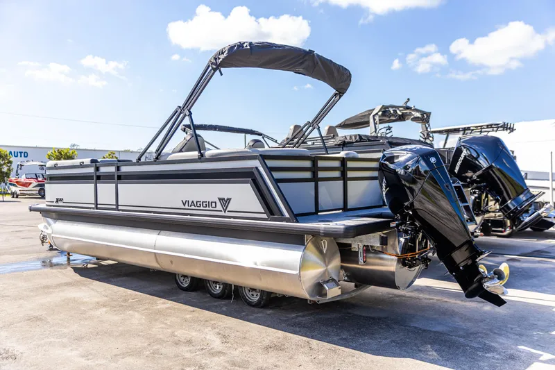 The Image of 2026 Viaggio Lago X-U pontoon boat with dual outboard motors, parked on a sunny day. - 0
