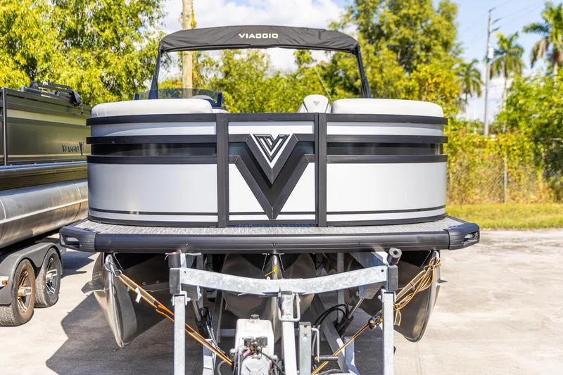 Slide: The Image of 2026 Viaggio Lago X-U pontoon boat on trailer, parked outdoors. - 10