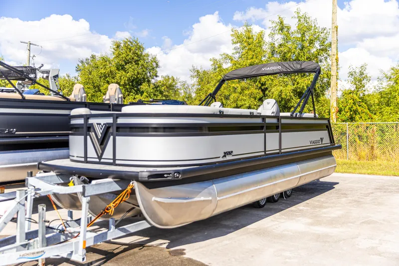 Slide: The Image of 2026 Viaggio Lago X-U pontoon boat on trailer, sunny day, outdoor setting. - 11