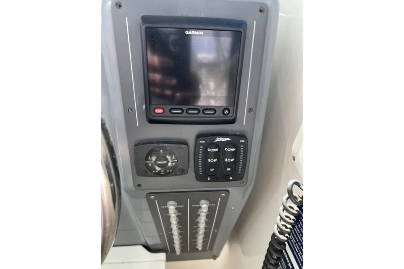 Slide: The Image of 1995 Tiara Yachts 3100 Open control panel with Garmin display and switches. - 11