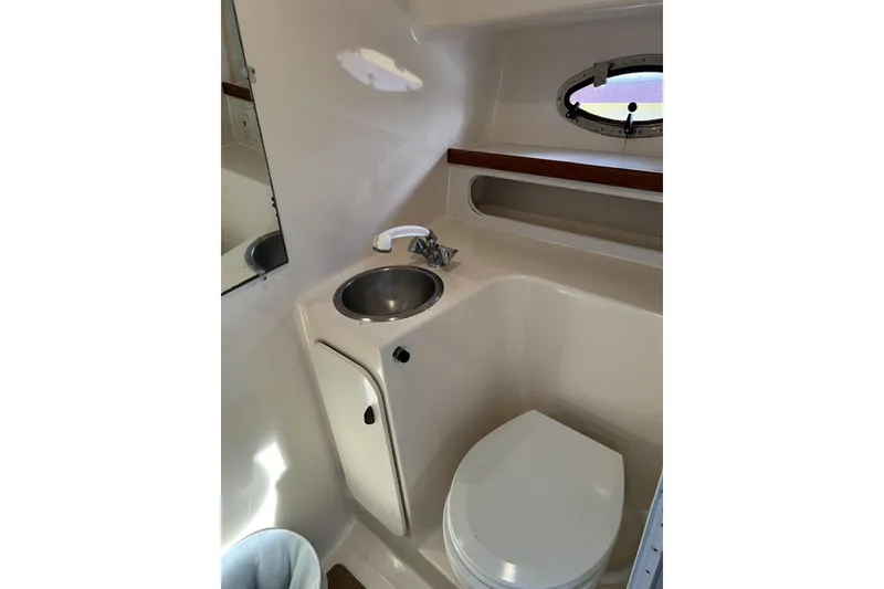Slide: The Image of Bathroom interior of 1995 Tiara Yachts 3100 Open, featuring sink and toilet. - 16