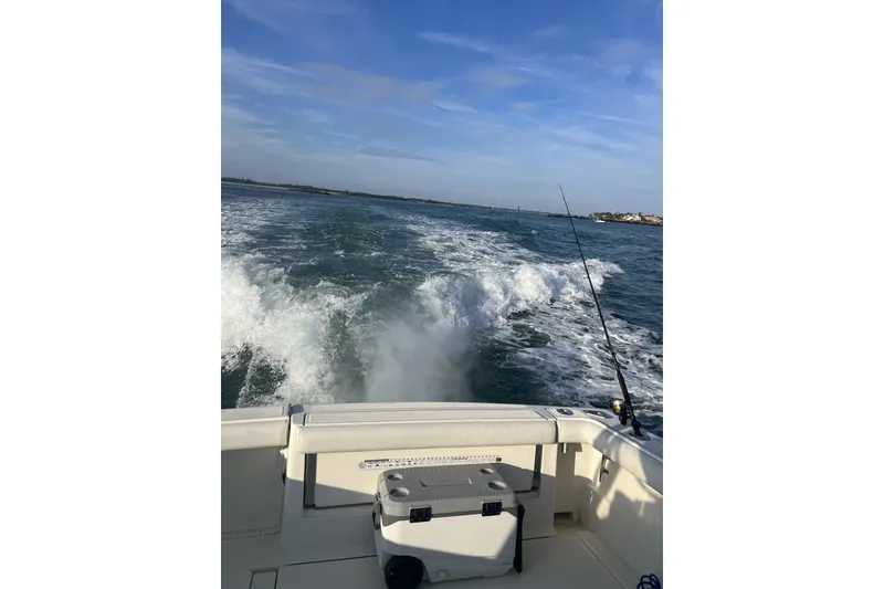 Slide: The Image of 1995 Tiara Yachts 3100 Open cruising on open water with fishing gear. - 20