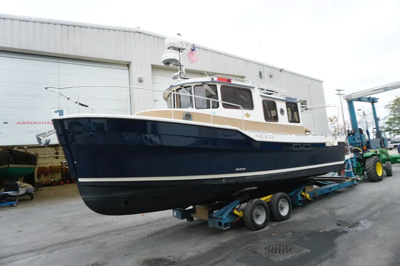 The Image of 2013 Ranger Tugs S-31 boat on trailer outside a warehouse. - 1