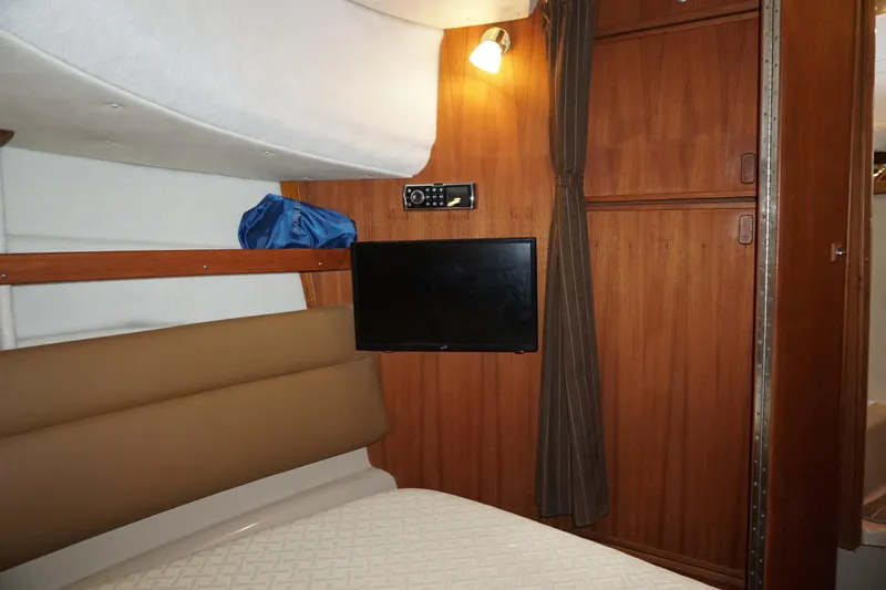 Slide: The Image of Interior cabin of 2013 Ranger Tugs S-31 with TV and wooden paneling. - 15