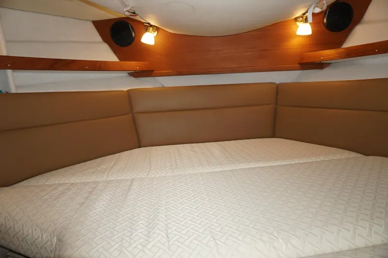 Slide: The Image of 2013 Ranger Tugs S-31 interior cabin with cozy bed and ambient lighting. - 18