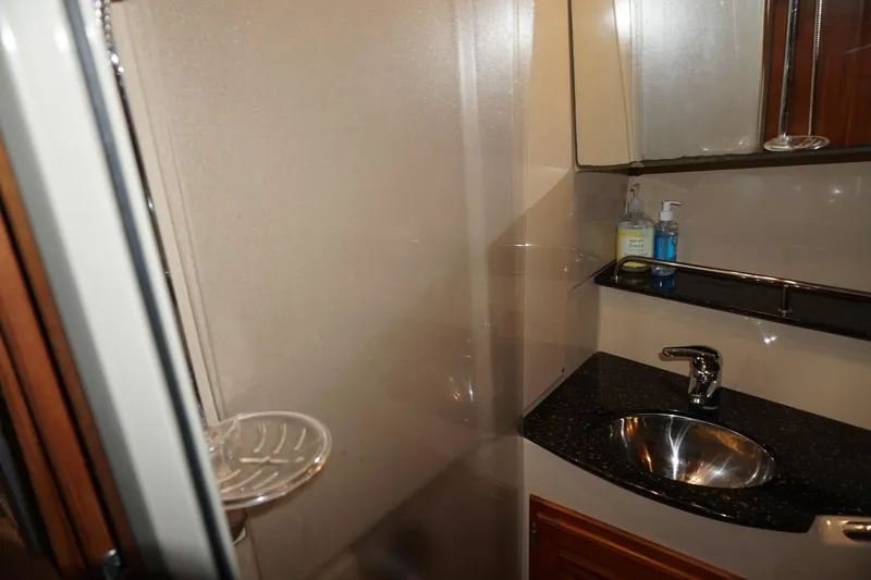 Slide: The Image of 2013 Ranger Tugs S-31 bathroom with sink, mirror, and soap dispensers. - 20