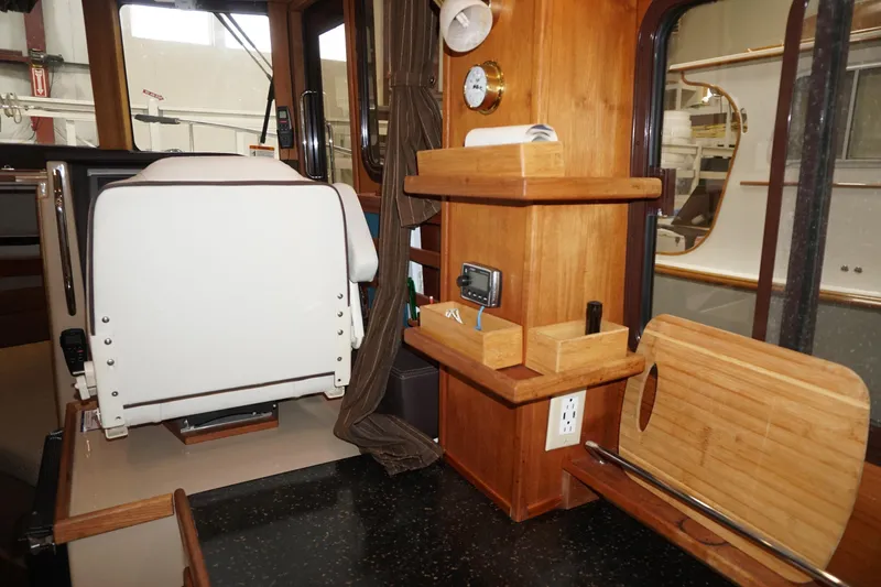 Slide: The Image of Interior of 2013 Ranger Tugs S-31 boat with wooden shelves and seating. - 26