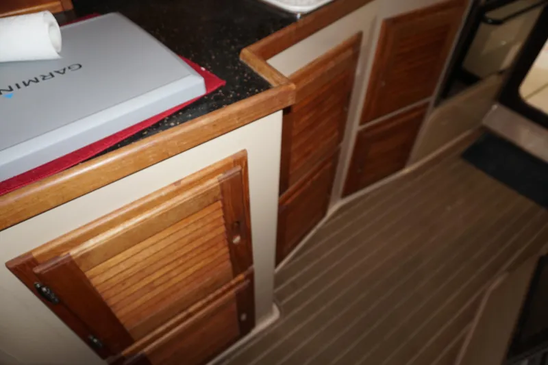 Slide: The Image of Interior of 2013 Ranger Tugs S-31 with wooden cabinets and Garmin equipment. - 28