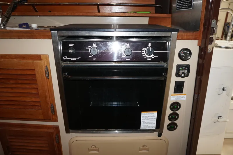 Slide: The Image of 2013 Ranger Tugs S-31 interior with built-in oven and control panel. - 29