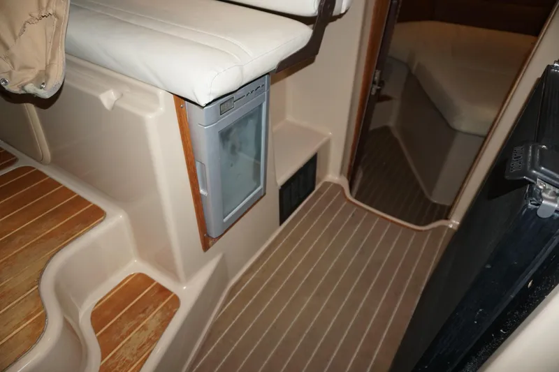 Slide: The Image of 2013 Ranger Tugs S-31 interior with wood flooring and compact seating area. - 34