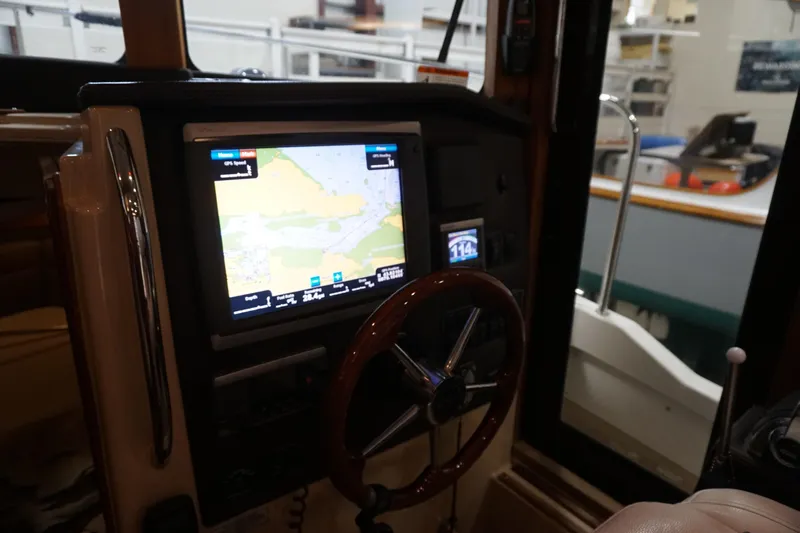 Slide: The Image of 2013 Ranger Tugs S-31 helm with GPS navigation display and steering wheel. - 41