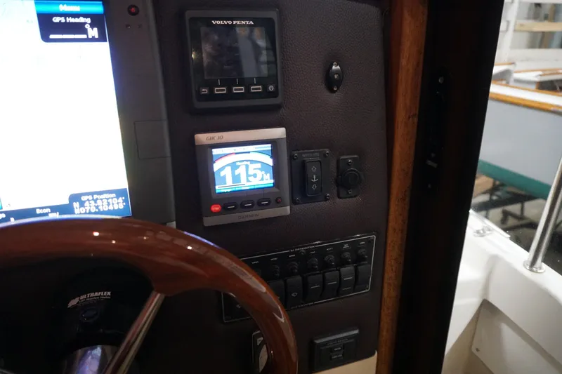 Slide: The Image of 2013 Ranger Tugs S-31 dashboard with navigation and control instruments. - 43