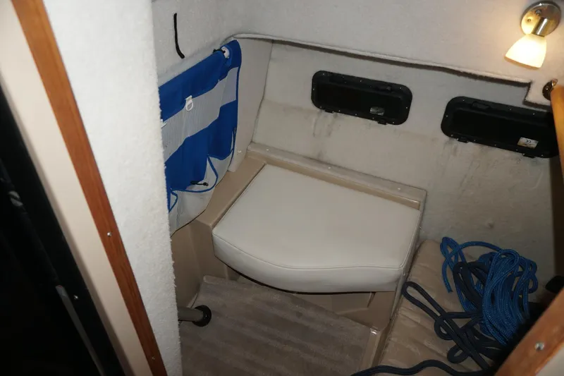 Slide: The Image of 2013 Ranger Tugs S-31 interior cabin with seating, storage, and nautical decor. - 46
