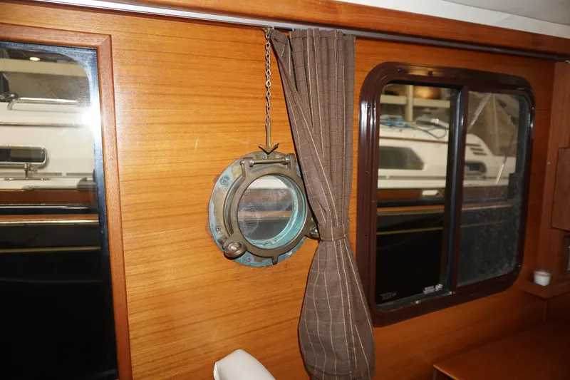 Slide: The Image of Interior of 2013 Ranger Tugs S-31 with wooden paneling and nautical decor. - 49