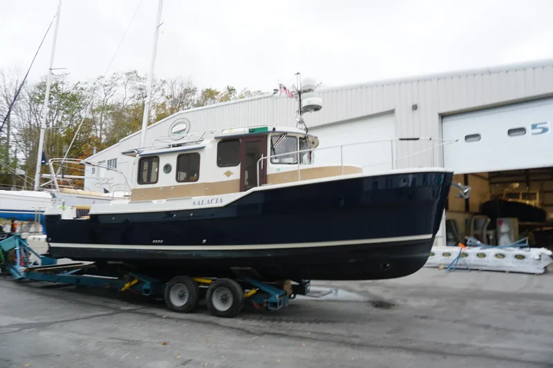 Slide: The Image of 2013 Ranger Tugs S-31 boat on trailer outside a storage facility. - 5