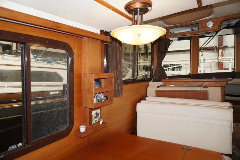 Slide: The Image of Interior of 2013 Ranger Tugs S-31 boat with wood paneling and seating area. - 50