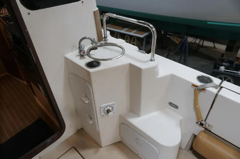 Slide: The Image of 2013 Ranger Tugs S-31 boat interior with sink and storage compartments. - 54