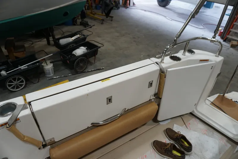 Slide: The Image of 2013 Ranger Tugs S-31 boat interior with seating and storage, in a workshop setting. - 55