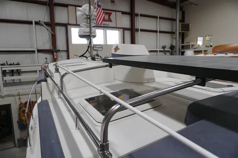 Slide: The Image of 2013 Ranger Tugs S-31 boat with solar panel and radar in a warehouse. - 58