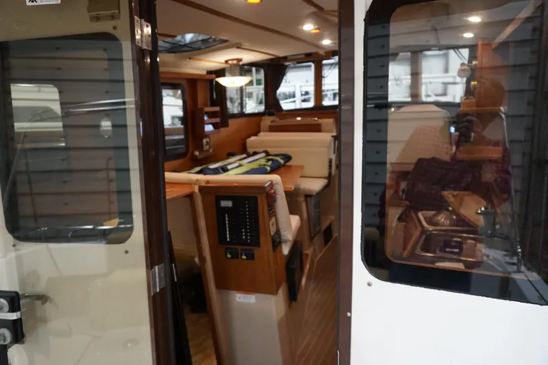 Slide: The Image of Interior view of 2013 Ranger Tugs S-31 boat, showcasing cozy cabin and seating area. - 66