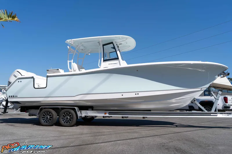 Slide: The Image of 2026 Sea Hunt Ultra 285 SE boat on trailer under clear blue sky. - 10