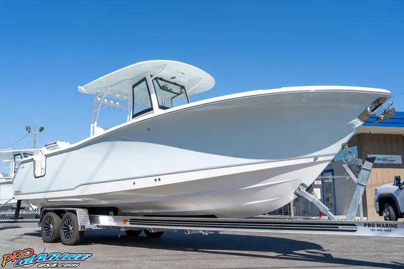 Slide: The Image of 2026 Sea Hunt Ultra 285 SE boat on trailer, displayed outdoors under clear blue sky. - 11