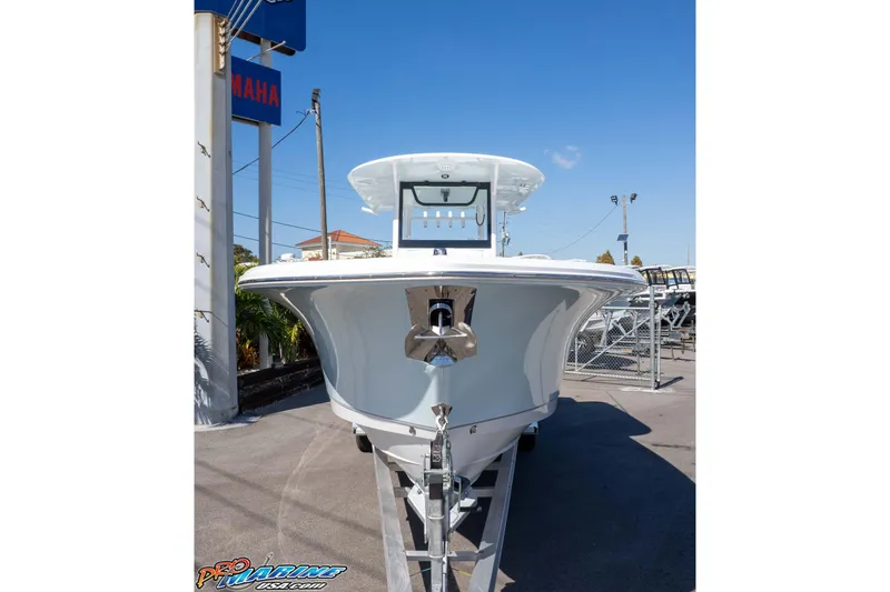Slide: The Image of 2026 Sea Hunt Ultra 285 SE boat on trailer at dealership, clear blue sky. - 12