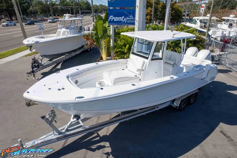 Slide: The Image of 2026 Sea Hunt Ultra 285 SE boat on trailer at dealership, sunny day. - 2