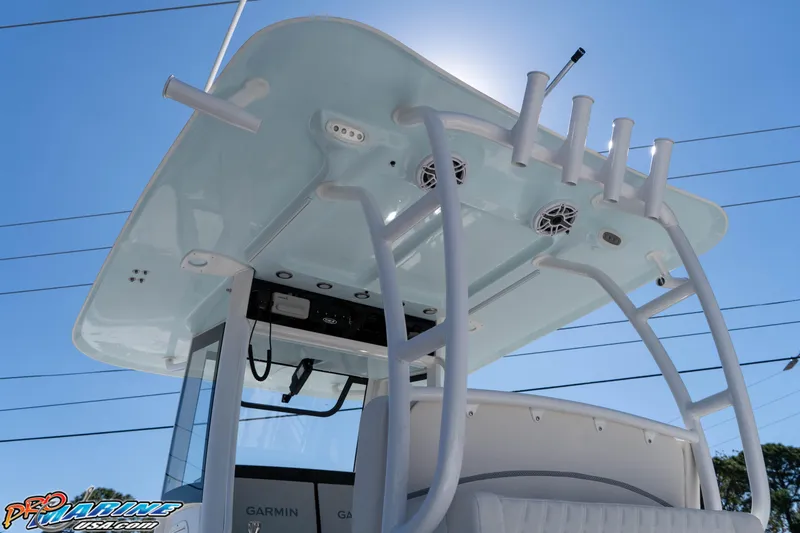 Slide: The Image of 2026 Sea Hunt Ultra 285 SE boat with T-top and rod holders under clear blue sky. - 20