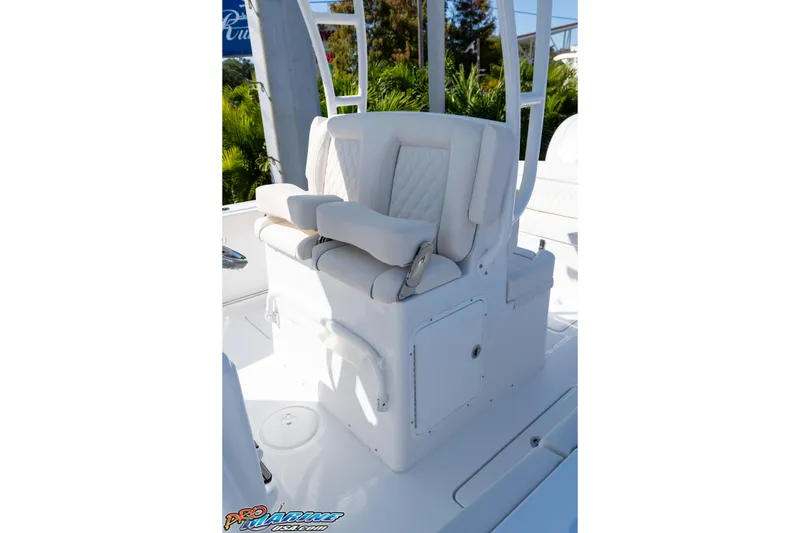 Slide: The Image of 2026 Sea Hunt Ultra 285 SE boat seating with white cushioned upholstery. - 24