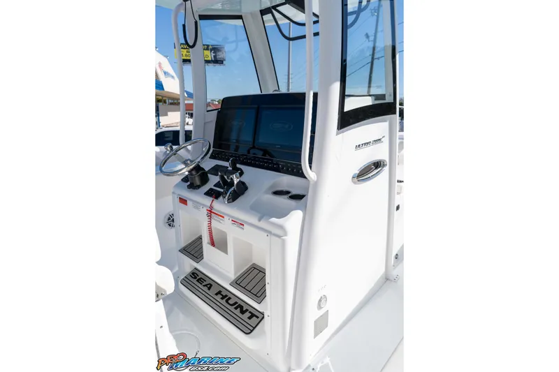 Slide: The Image of 2026 Sea Hunt Ultra 285 SE boat console with steering wheel and controls. - 26